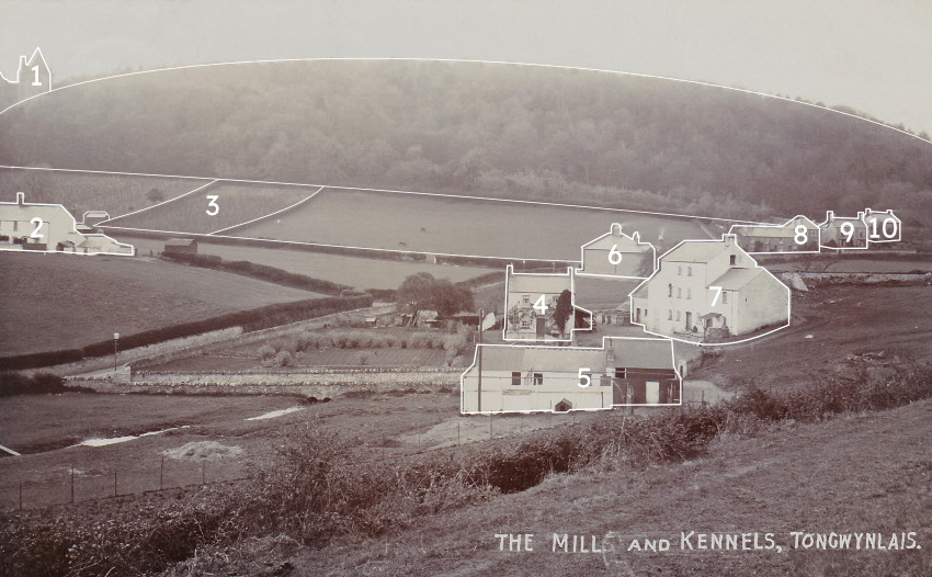 A view of an old mill, kennels and residential houses in the background with outlines around the buildings