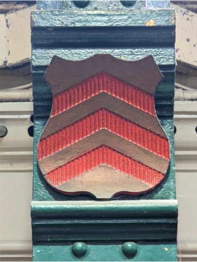 Close up photo of a pillar in Cardiff Market that features the Villa Cardiff crest.