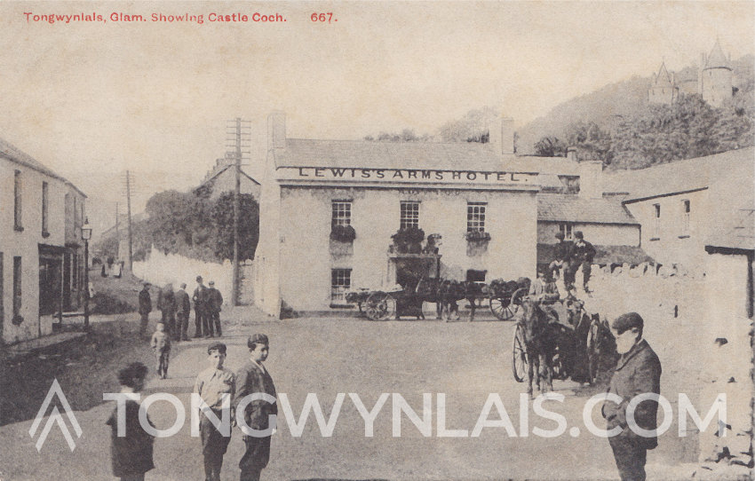 Postcard featuring the Lewis Arms from 1907. There are some horse and carts and people stood in the village square.